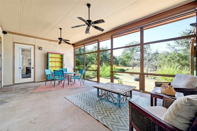 sunroom featuring a ceiling fan