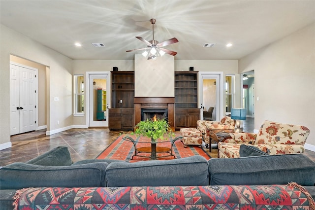 living room featuring visible vents, baseboards, a warm lit fireplace, and a ceiling fan