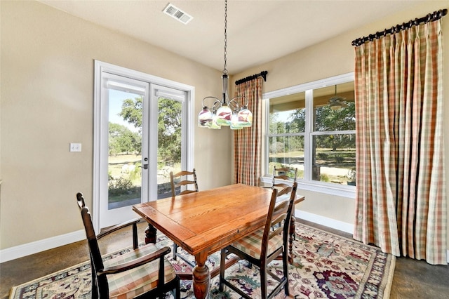 dining area with visible vents, french doors, concrete flooring, and baseboards