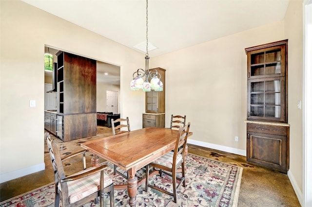 dining area featuring baseboards and a chandelier