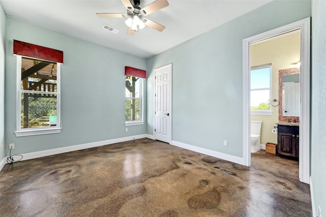 interior space featuring visible vents, ceiling fan, concrete flooring, and baseboards