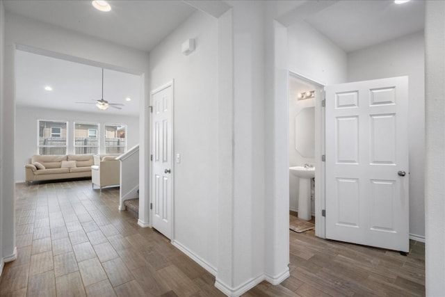 hallway with wood-type flooring and sink