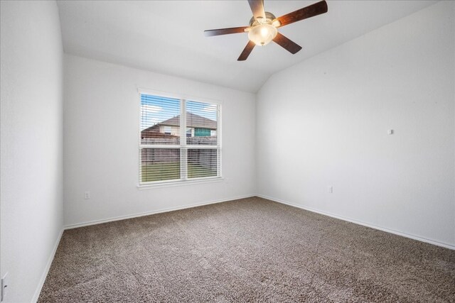 empty room with ceiling fan, lofted ceiling, and carpet floors