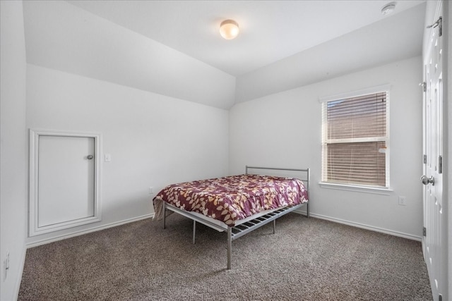 carpeted bedroom with lofted ceiling