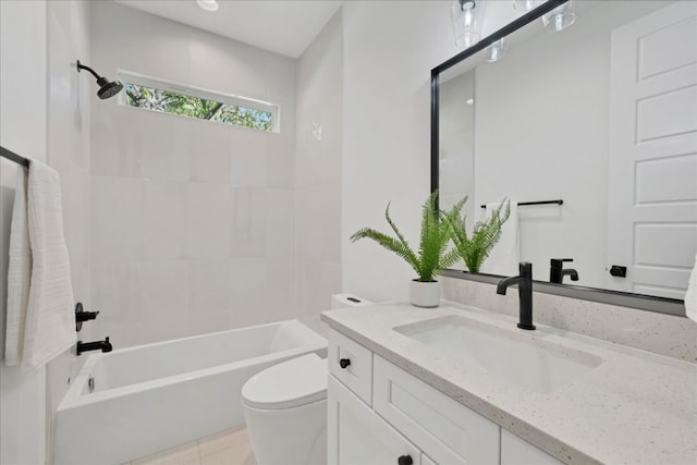 full bathroom featuring vanity, tiled shower / bath, and toilet