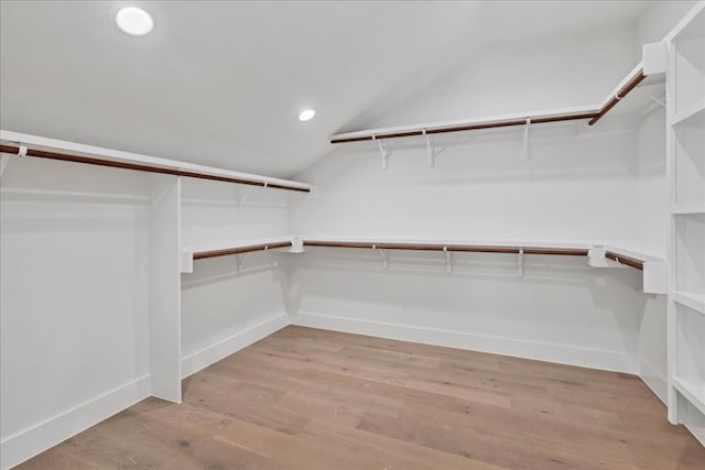 walk in closet featuring lofted ceiling and light hardwood / wood-style floors