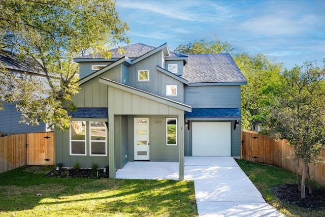 view of front of property featuring a garage and a front lawn