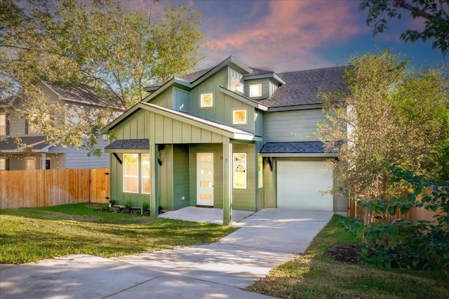 view of front of house with a garage and a lawn