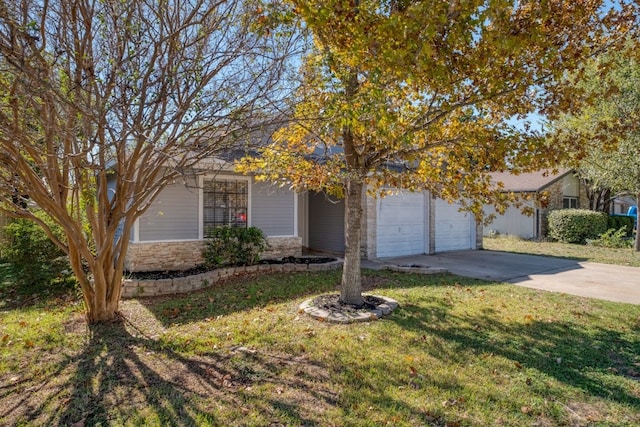 obstructed view of property featuring a front lawn and a garage