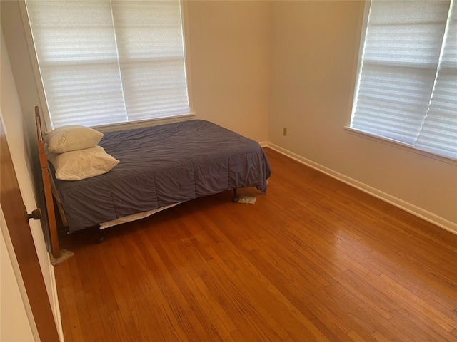 bedroom with wood-type flooring