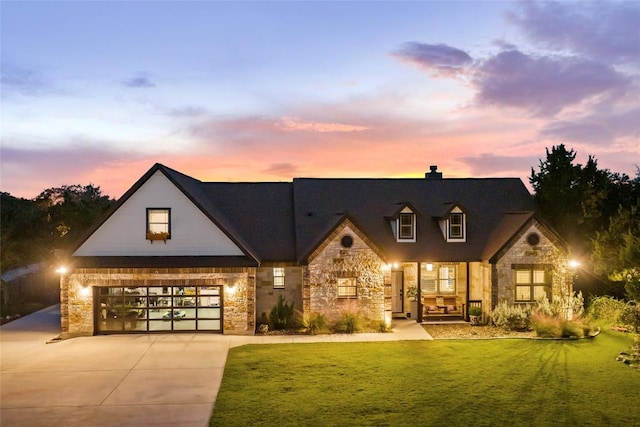 view of front of house featuring a garage and a lawn