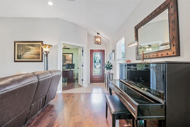 foyer entrance featuring a chandelier, hardwood / wood-style floors, and vaulted ceiling