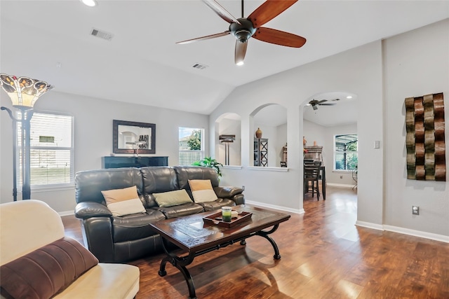 living room featuring lofted ceiling, ceiling fan, wood-type flooring, and a wealth of natural light