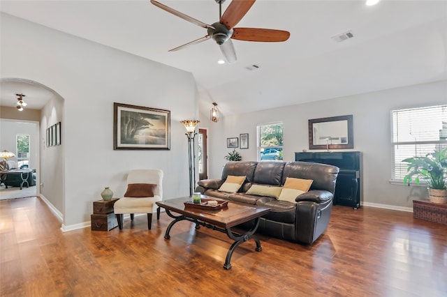 living room with dark hardwood / wood-style flooring, ceiling fan, and lofted ceiling