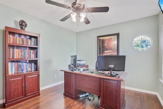 home office with ceiling fan and dark hardwood / wood-style floors