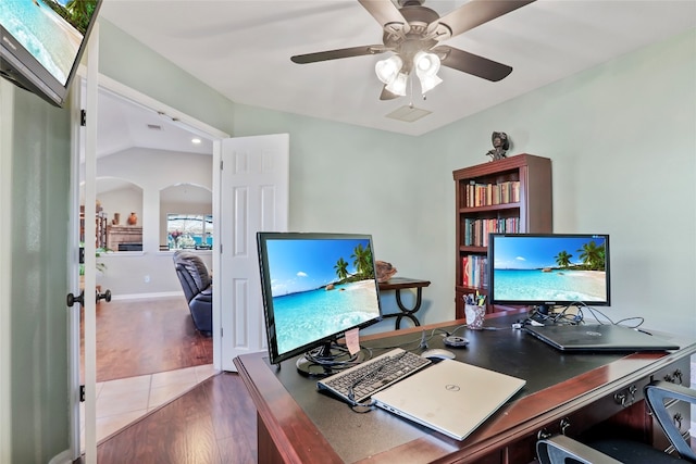 office area featuring hardwood / wood-style flooring, ceiling fan, and vaulted ceiling