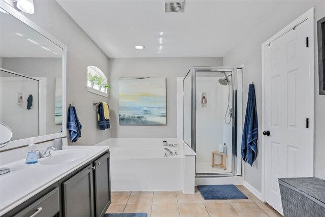 bathroom featuring tile patterned floors, vanity, and plus walk in shower