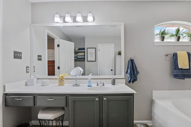 bathroom featuring vanity and a bath