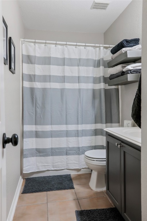 bathroom with tile patterned floors, a shower with curtain, vanity, and toilet