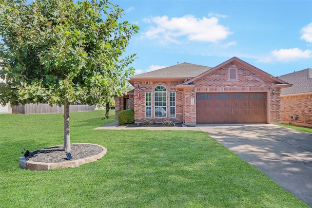 view of front of property featuring a garage and a front lawn