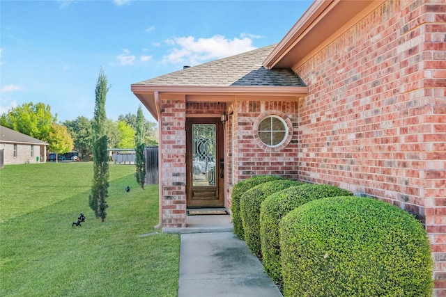 property entrance with a lawn