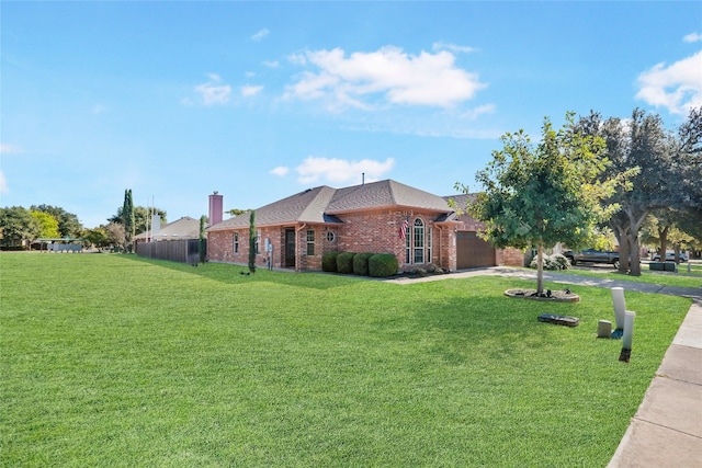 view of side of property with a yard and a garage