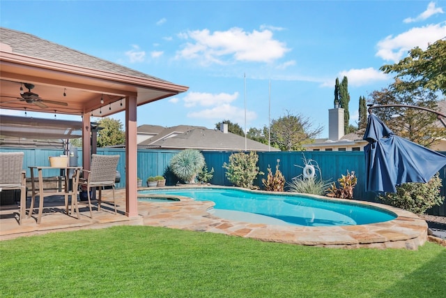 view of pool with ceiling fan, a yard, and a patio