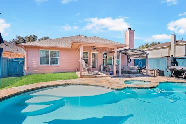 back of property with ceiling fan, a swimming pool with hot tub, a patio, and an outdoor living space