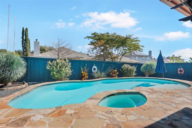 view of swimming pool with an in ground hot tub