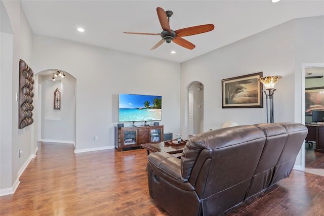 living room with dark hardwood / wood-style flooring and ceiling fan