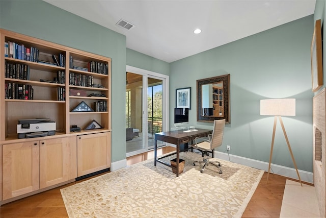 office with light hardwood / wood-style flooring