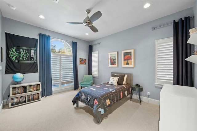 bedroom featuring light colored carpet and ceiling fan