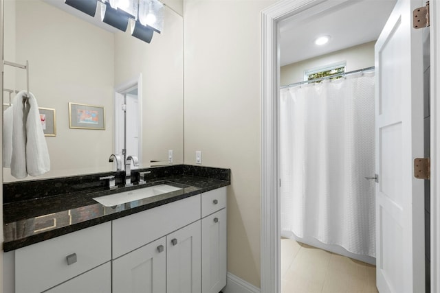 bathroom with a shower with curtain and vanity