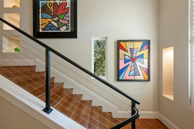 stairs featuring wood-type flooring