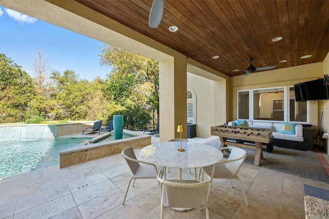 view of patio / terrace with pool water feature and ceiling fan