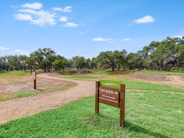 view of home's community with a yard