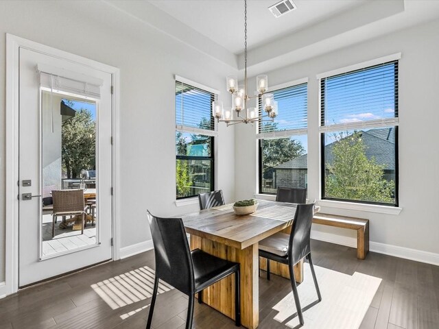 dining room featuring a chandelier and dark hardwood / wood-style floors