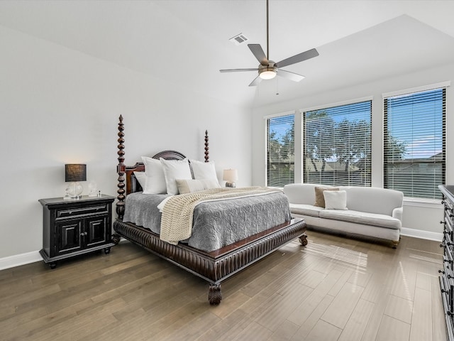 bedroom featuring ceiling fan, dark hardwood / wood-style floors, and vaulted ceiling