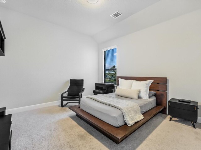 bedroom featuring carpet flooring and lofted ceiling