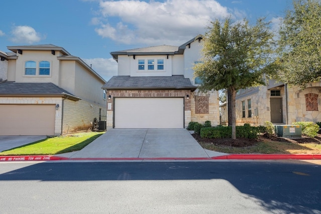 view of front of property featuring a garage and central air condition unit