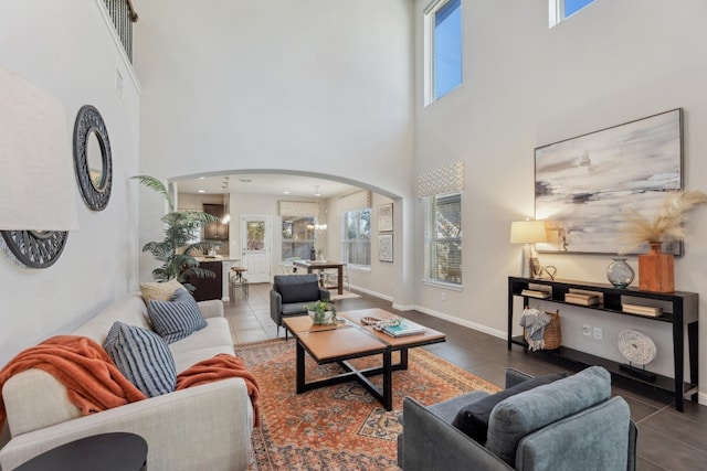 tiled living room with plenty of natural light and a high ceiling