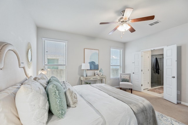 bedroom with ceiling fan, multiple windows, a spacious closet, and light carpet