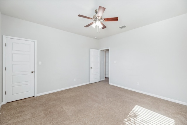 unfurnished room featuring light colored carpet and ceiling fan