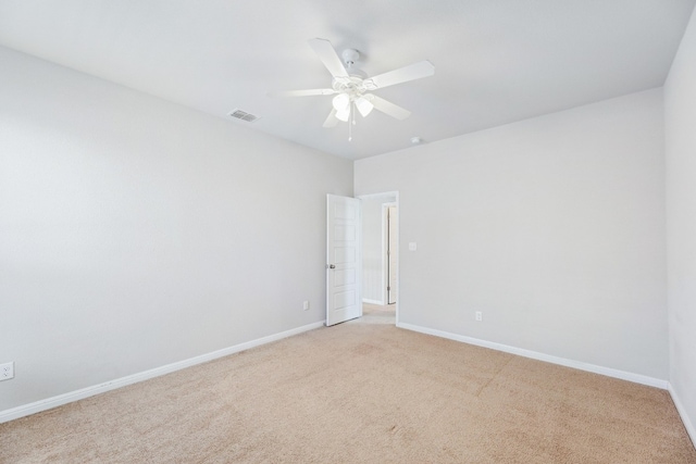 spare room featuring ceiling fan and light colored carpet