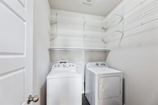 washroom featuring washing machine and clothes dryer