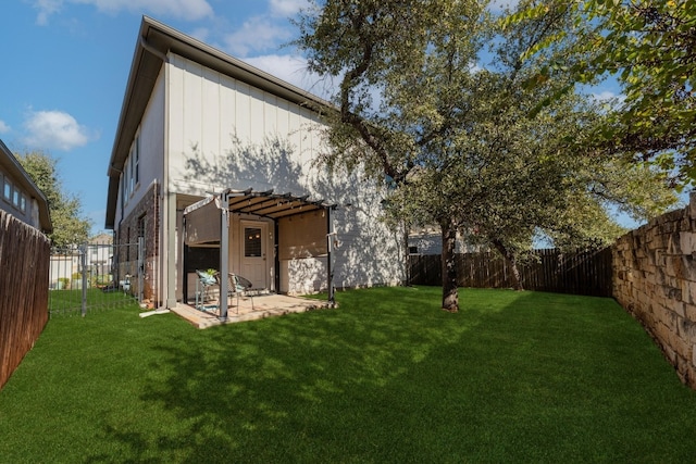 back of house with a patio area and a yard