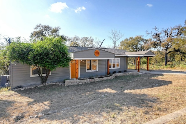 single story home with a carport and central AC unit