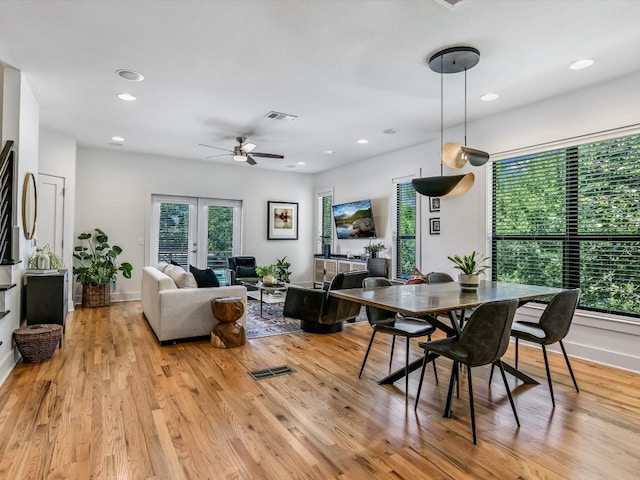 dining area with french doors, light hardwood / wood-style floors, and ceiling fan