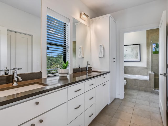 full bathroom featuring tile patterned floors, vanity, toilet, and shower with separate bathtub