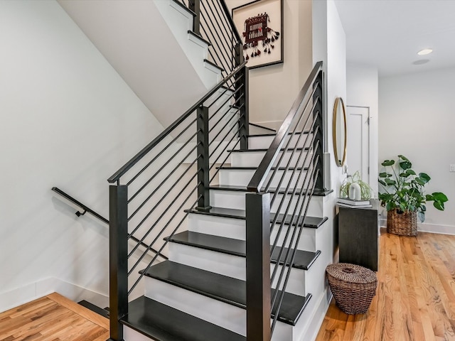 staircase with wood-type flooring